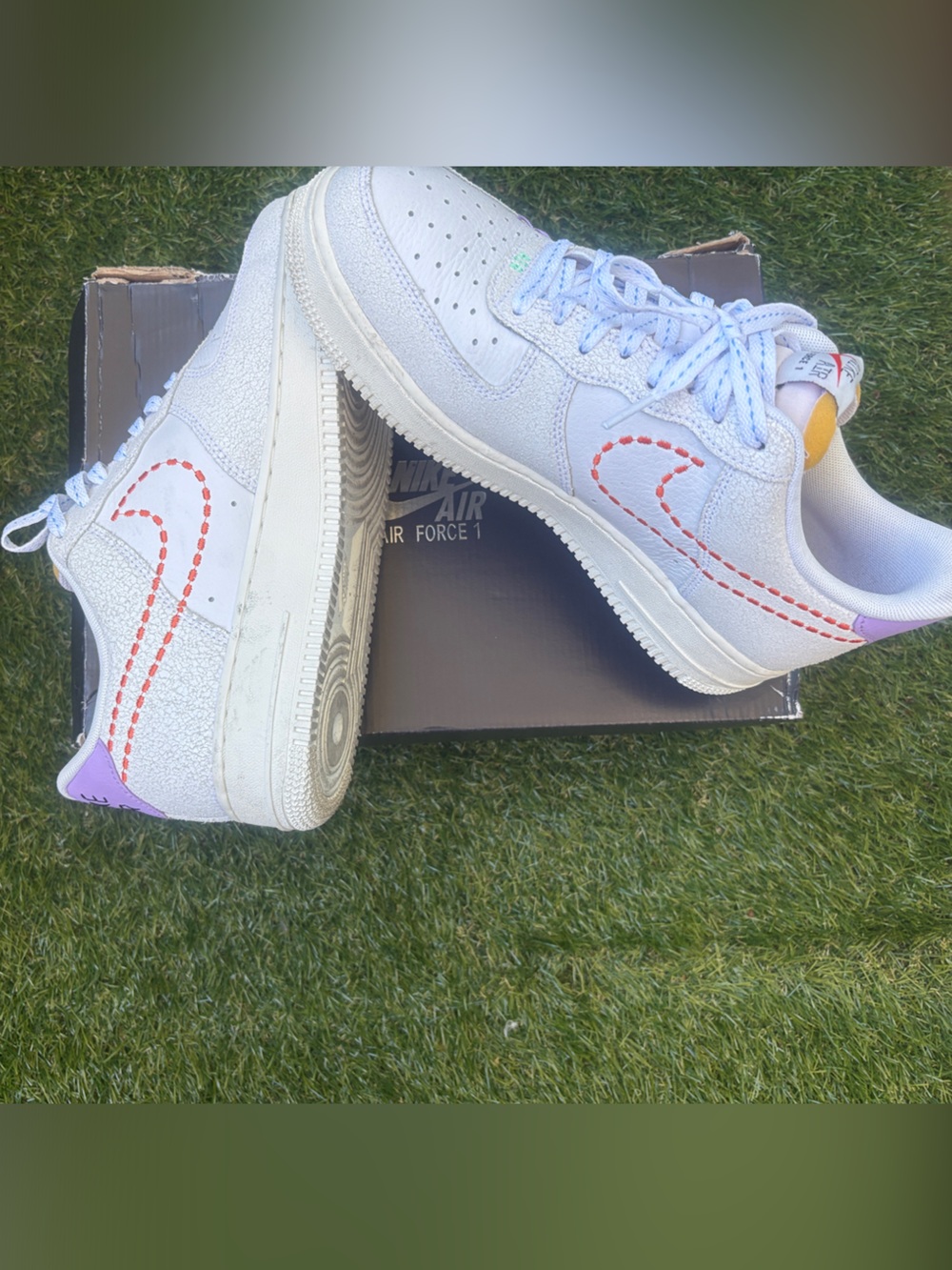 Nike White Sneakers with Orange Stitching and Purple Heel Accent